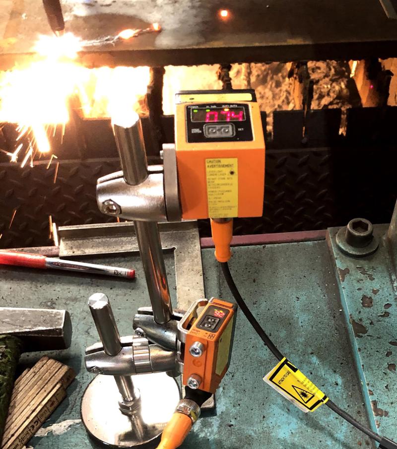 Retrofitted light barrier from ifm, deployed in a steel factory at a plasma cutting machine